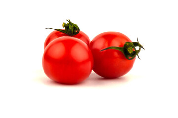 Several cherry tomatoes on a white background.
