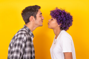young couple in kiss pose isolated on color background