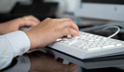 hands of a woman on white keyboard