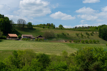 farmer at work on his tractor next to his farm in Zunzgen, Baselland in Switzerland