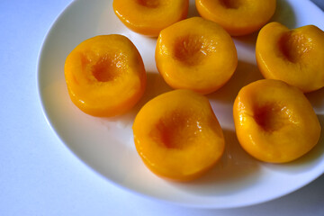 Marinated sliced peaches on a white plate