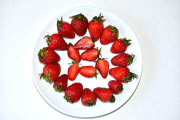 Sliced strawberries or Victoria on a white plate
