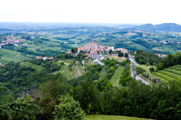 Fototapeta na wymiar The view from the heights of the mountains, fields, and vineyards of the Italian foothills of the Alps