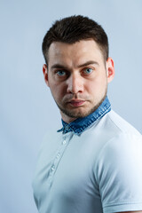 Fototapeta premium Portrait of a man in a white polo on a white background. Male image for every day. Stylish guy