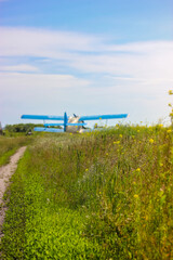 Aeroplane in summer field: commercial and agricultural helicopter service © vita