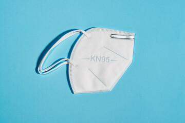 White mask with reusable KN95 protection index for virus protection on light blue background