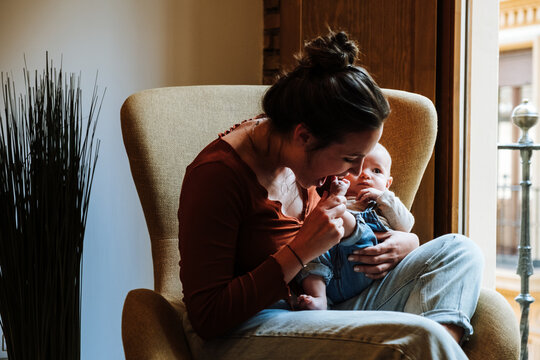 Mother with baby sitting near window