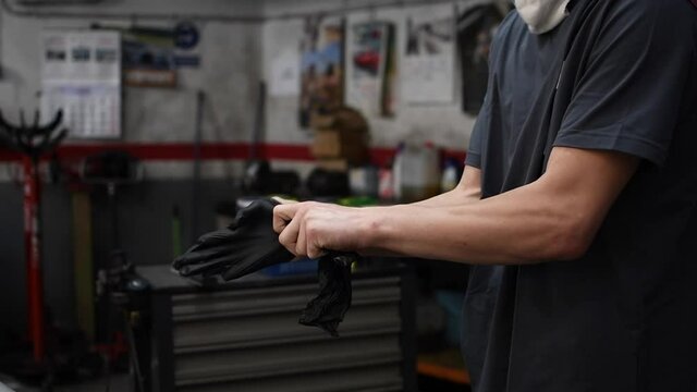 mechanic putting on work gloves