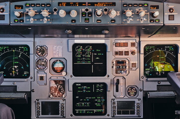 Closeup of control panel with modern facilities and digital displays in cockpit of contemporary aircraft