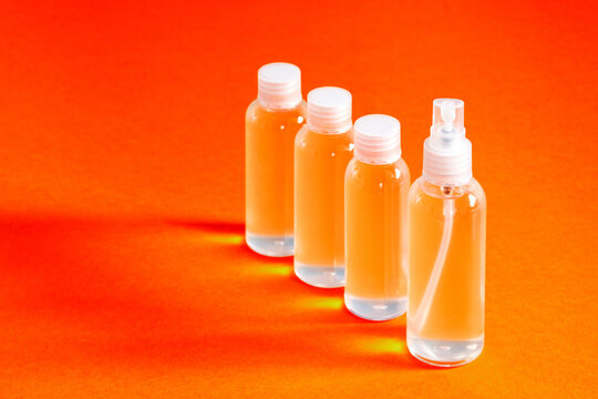 several clear bottles with hydrochloric gel along with a funnel to fill serves to disinfect covid-19's hands top view