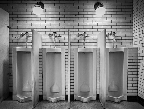 Interior of illuminated public restroom with brick wall in public building of New York City