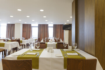 Hotel dining room interior with wooden wall.