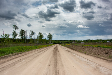 country road in the countryside with cloudy sky