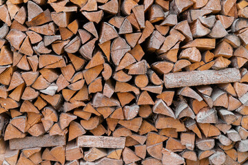 A lot of stacked chopped firewood prepared for use.