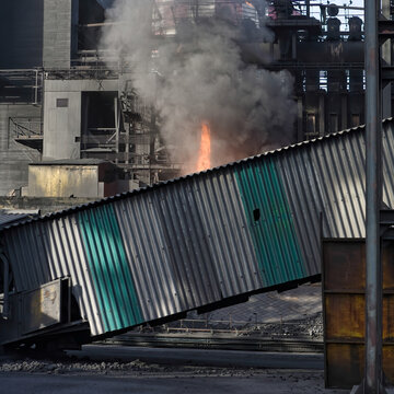 Flame of burning coke during process of converting from coal in industrial area of factory