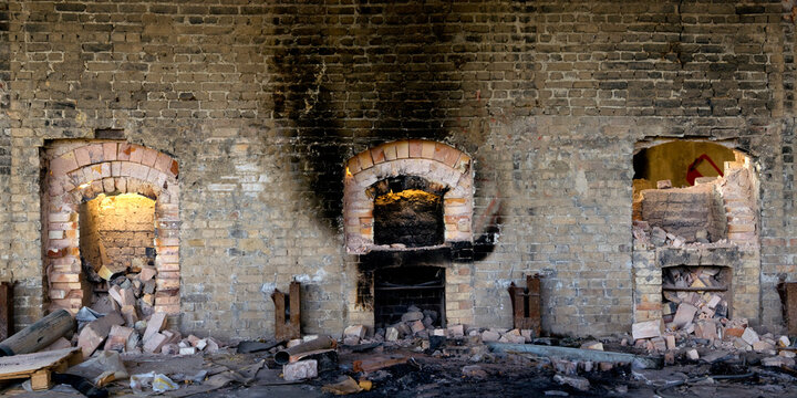 Wide Angle View Of Aged Stone Wall With Destroyed Furnaces And Trash Inside Abandoned Industrial Factory