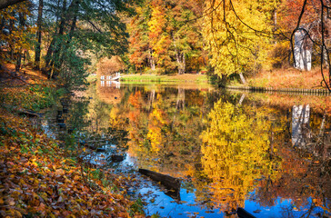 Reflections of colorful autumn trees in the Tsaritsyno pond in Moscow