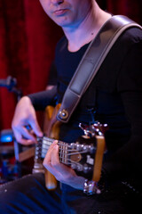 Artist Guitarist hand play bass Guitar on Stage