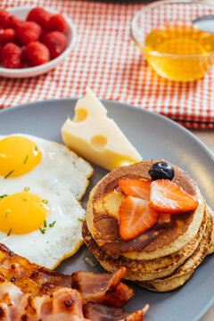 Delicious fried eggs with bacon and cheese for breakfast