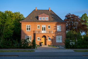 Big red 3 story brick house with 2 chimneys
