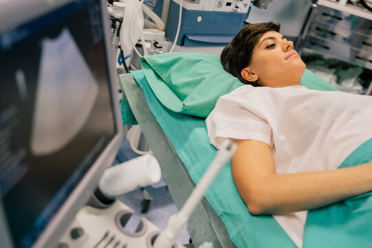 View Of Ultrasound Scanner With Pregnant Woman Begin Exterminate In Modern Hospital