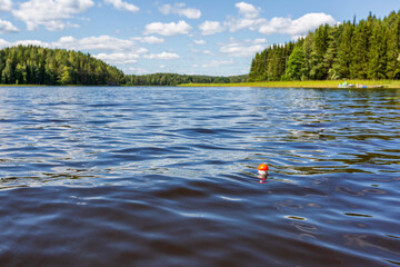 Beautiful landscape of the lake and the bobber on foreground, Finland - obrazy, fototapety, plakaty