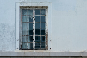 Fototapeta na wymiar Creepy old window at abandoned house.