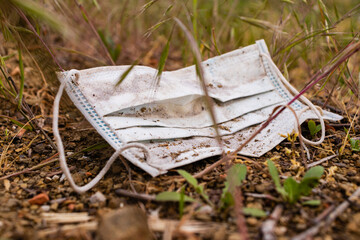Medical face mask find in the park after corona virus pandemic was over. Trash, garbage in the nature.