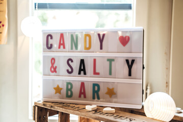 Colorful text in light box. Candy and salty bar label. Sign board with message on party,...