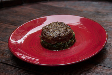 fried meat on a spinach pillow close-up. Dish of meat. Meat food