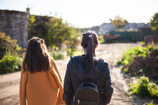 Girls on a sunny day. Teenagers go for a walk.