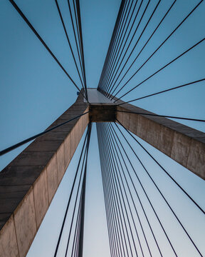 Fototapeta View of a pylon with attached cables holding up a cable suspended bridge.