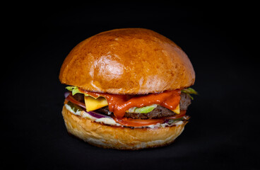 burger with chop, steak, cheese, salad on a black background