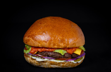 burger with chop, steak, cheese, salad on a black background