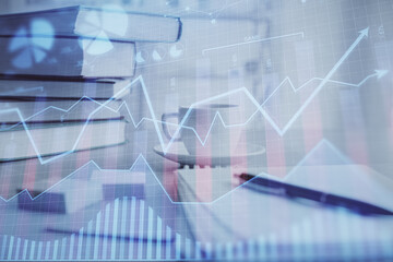 Double exposure of financial chart drawing and desktop with coffee and items on table background. Concept of forex market trading