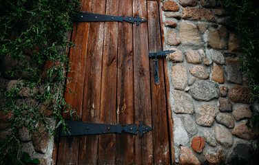 
Large old wooden door on a stone wall