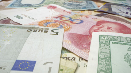 Close up view of different currency of the world scattered.