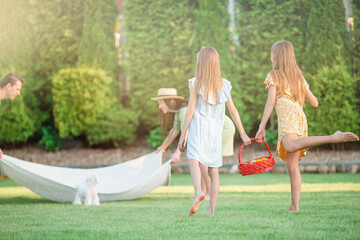 Happy family on a picnic in the park on a sunny day