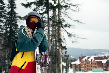 Portrait of a woman snowboarder in outdoor equipment.