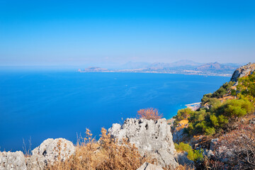 Fototapeta premium Romantic island of Sicily, wonderful view of seaside from high up, aerial view of blue Mediterranean sea with horizon over water in mist.. Sicily, Italy landscape.