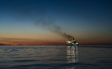 smoking ferryboat in the sunset