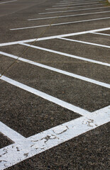 Fototapeta premium Abstract shots of parking lot with white and yellow stripes, arrows, signs, and symbols