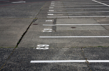 Abstract shots of parking lot with white and yellow stripes, arrows, signs, and symbols