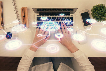 Double exposure of woman hands working on computer and social network theme hologram drawing. Top View. People connection concept.