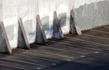 Abstract shots of parking lot with white and yellow stripes, arrows, signs, and symbols
