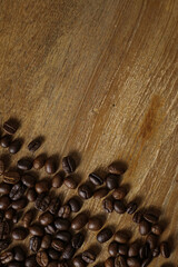 Coffee beans on wooden table with copyspace for text. Selective focus.