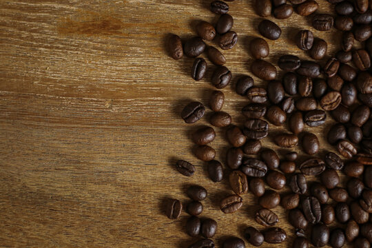 Coffee beans on wooden table with copyspace for text. Selective focus. © Sakchai