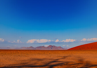 Naklejka na ściany i meble Mountains of the Namib Desert in the sunset in Sossusvlei in Namibia