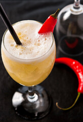 Caipirinha Brazilian typical drink, coktail of cachaça, exotic tropical flavor pineapple fruit juice with chili pepper, served on fresh ice cold glass. Close up view.