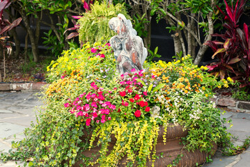 A closeup of a beautiful arrangement of flowers in a small courtyard garden.